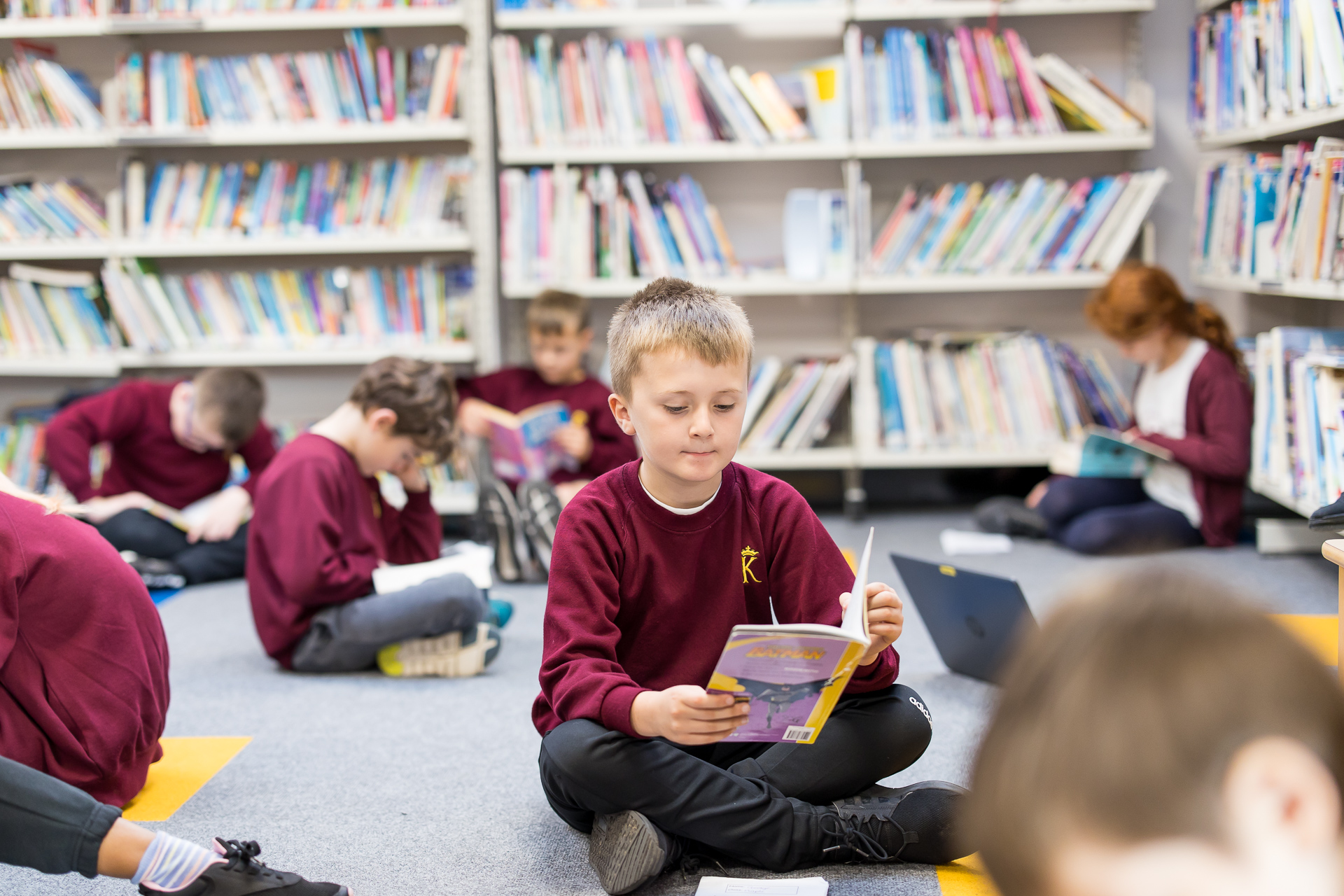 Boy reading in library