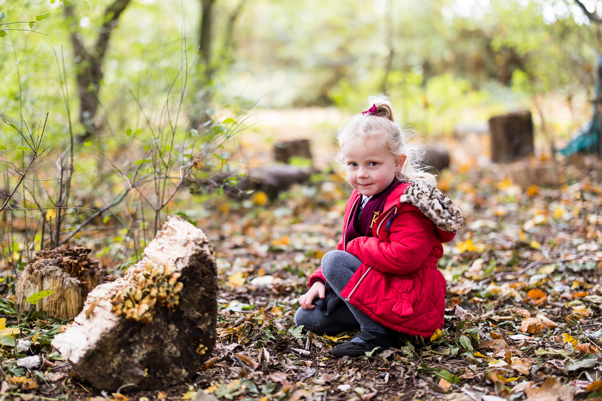 Young girl outside in wood area